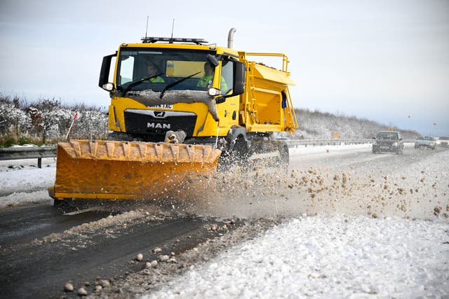 <p>A snow plough clears the A35 road between Dorchester and Bridport</p>