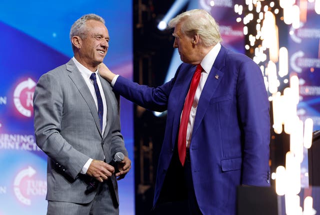 <p>Donald Trump welcomes Robert F. Kennedy Jr. to the stage at a Turning Point Action campaign rally at the Gas South Arena on October 23</p>