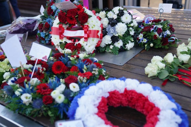 Wreaths are laid during a memorial service at 1000 Trades Square, outside New Street station in Birmingham to mark the 50th anniversary of Birmingham pub bombings (PA)