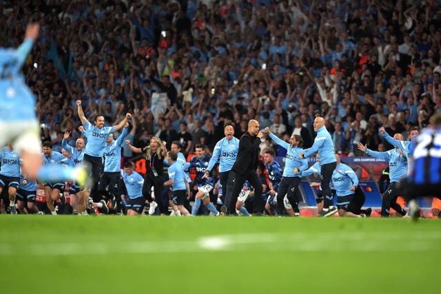 Pep Guardiola, centre, and Manchester City celebrate their Champions League win in 2023 (Martin Rickett/PA)