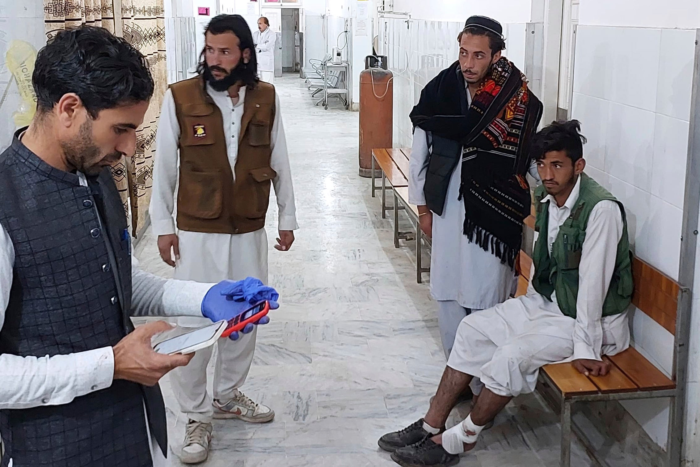 An injured person, on the right, receives treatment at a hospital in Parachinar, in the Kurram district of Pakistan’s northwestern Khyber Pakhtunkhwa province, on Thursday, 21 November 2024