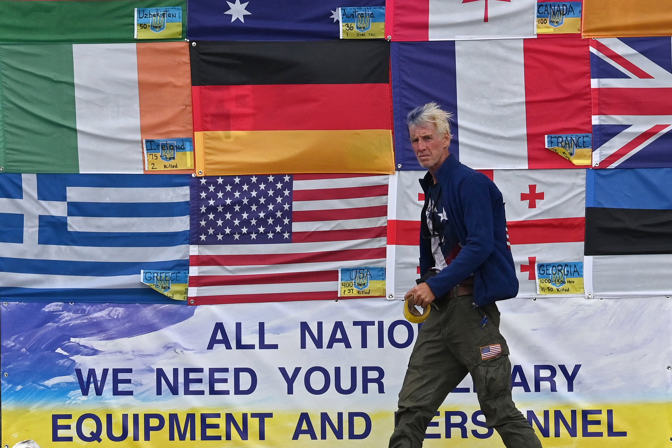 This photograph taken on Independence Square in Kyiv on June 23, 2022 shows US citizen Ryan Wesley Routh sticking up national flags of the countries helping Ukraine.