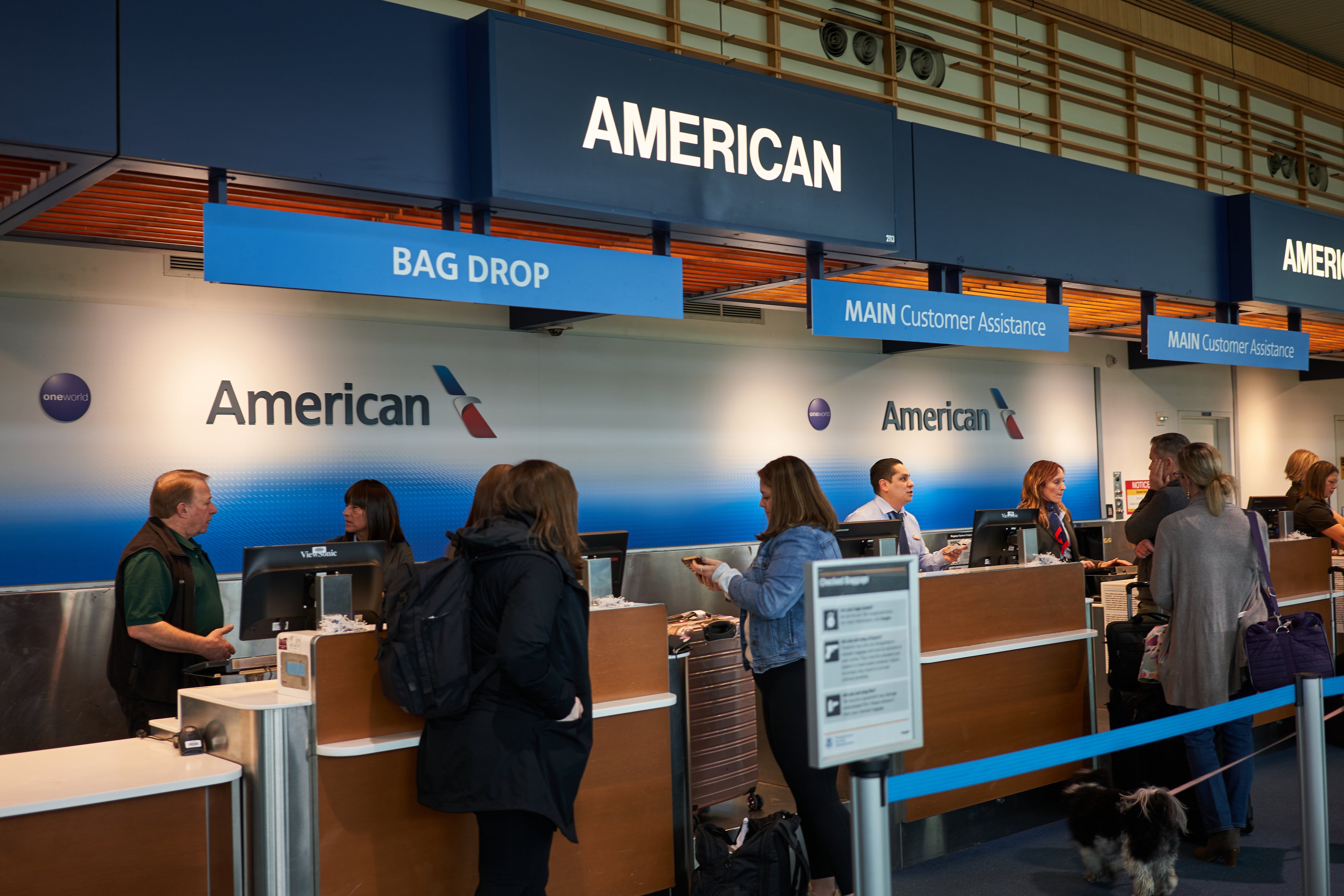 Passengers check their baggage at the American Airlines check-in desk in Portland International Airport