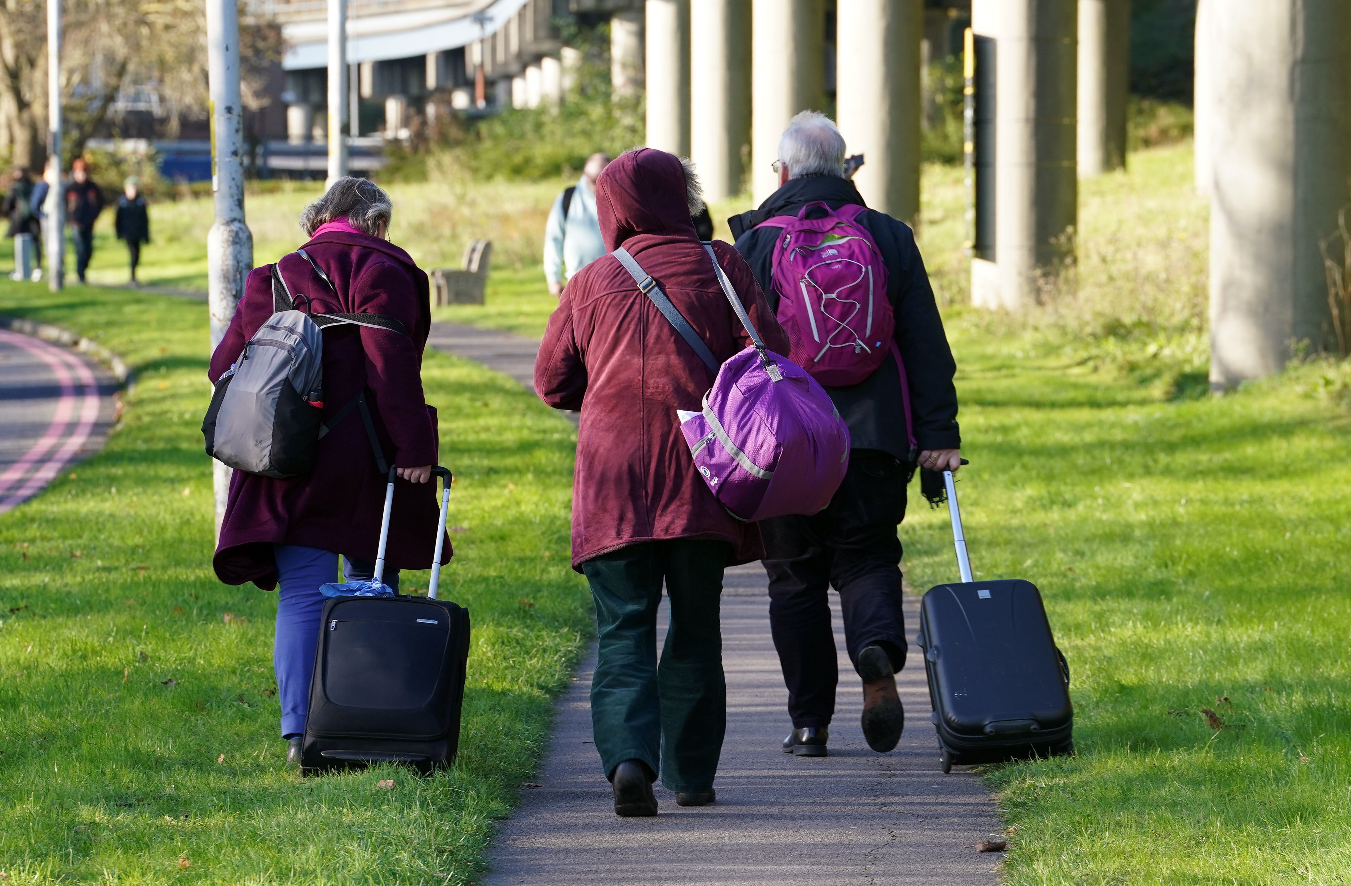 Passengers at Gatwick airport waiting with their luggage