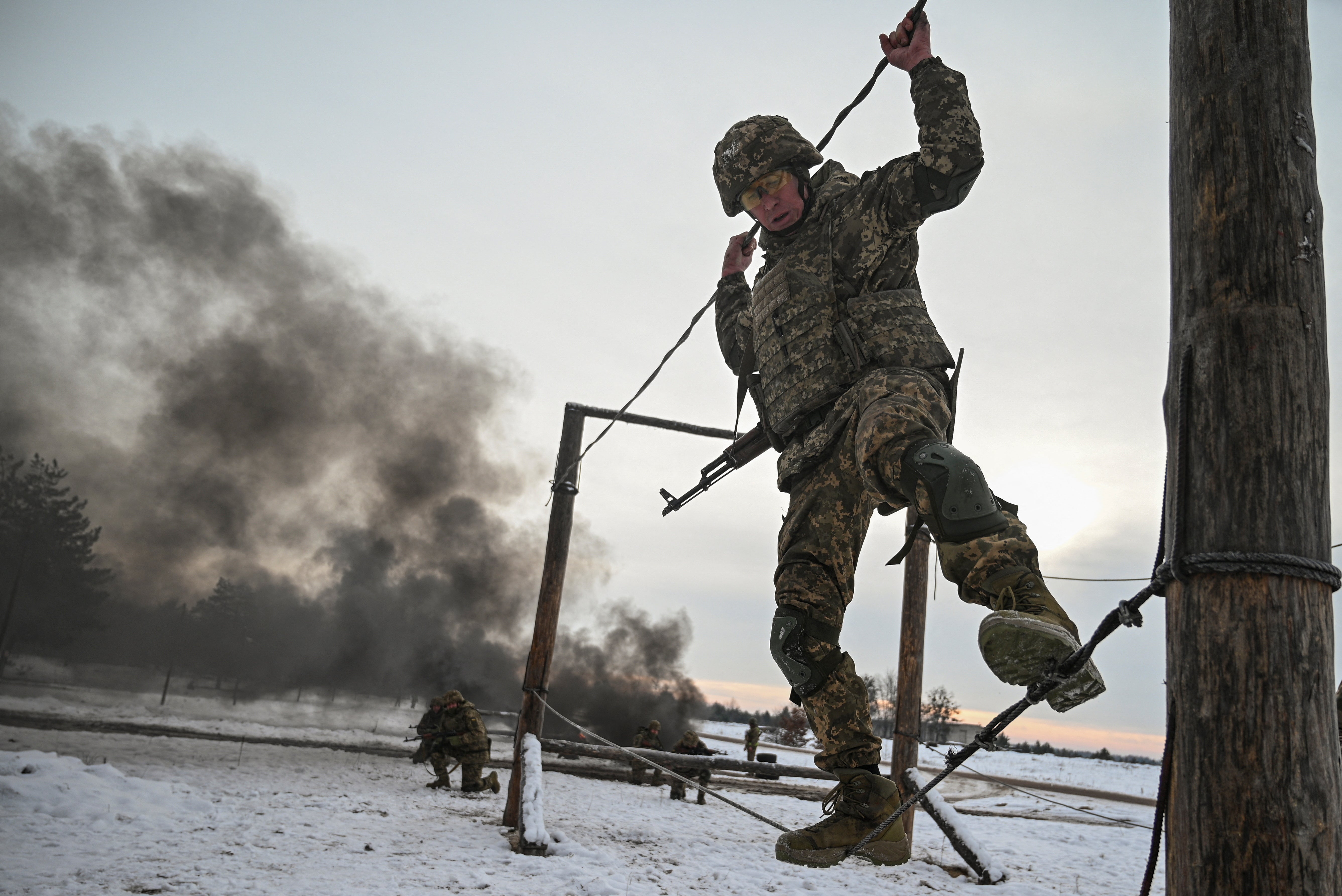 A Ukrainian solider balances on rope during military training exercises