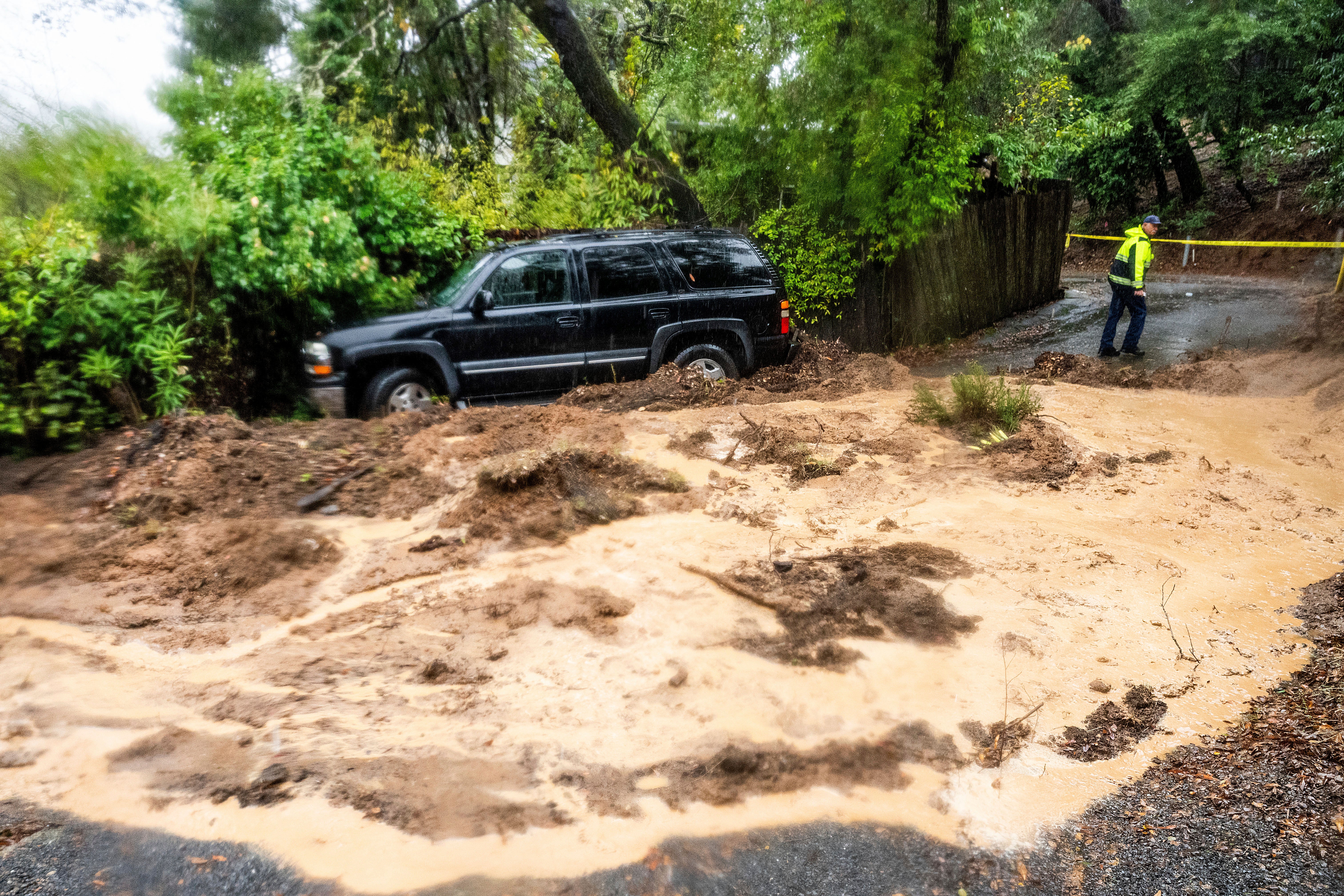 A firefighter evaluates a mudslide near Healdsburg in unincorporated Sonoma County, California, on Friday. The county saw record rainfall from the storm