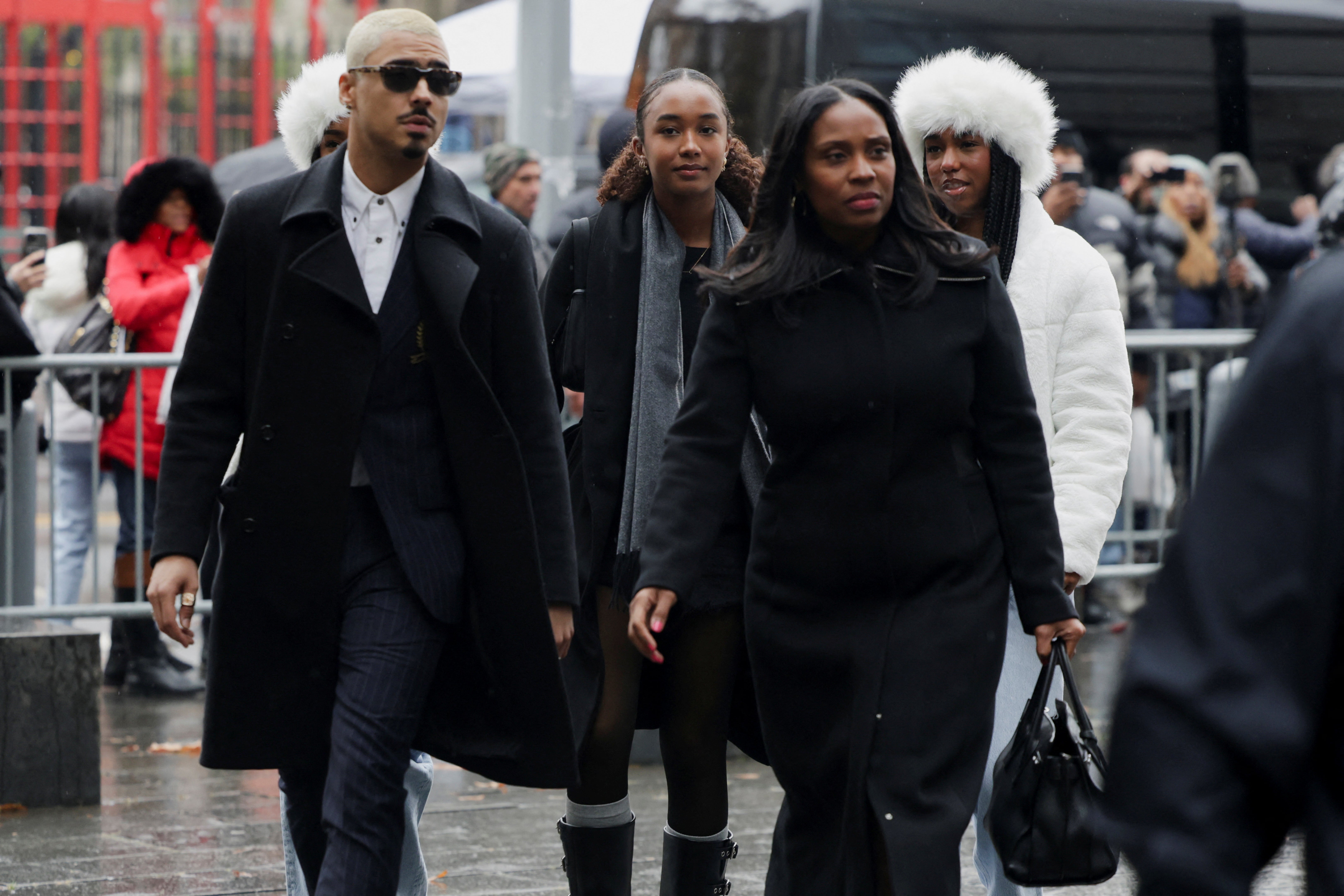 Quincy Brown, left, Diddy’s daughter Chance Combs, second left, and other supporters of the rapper arrive at court