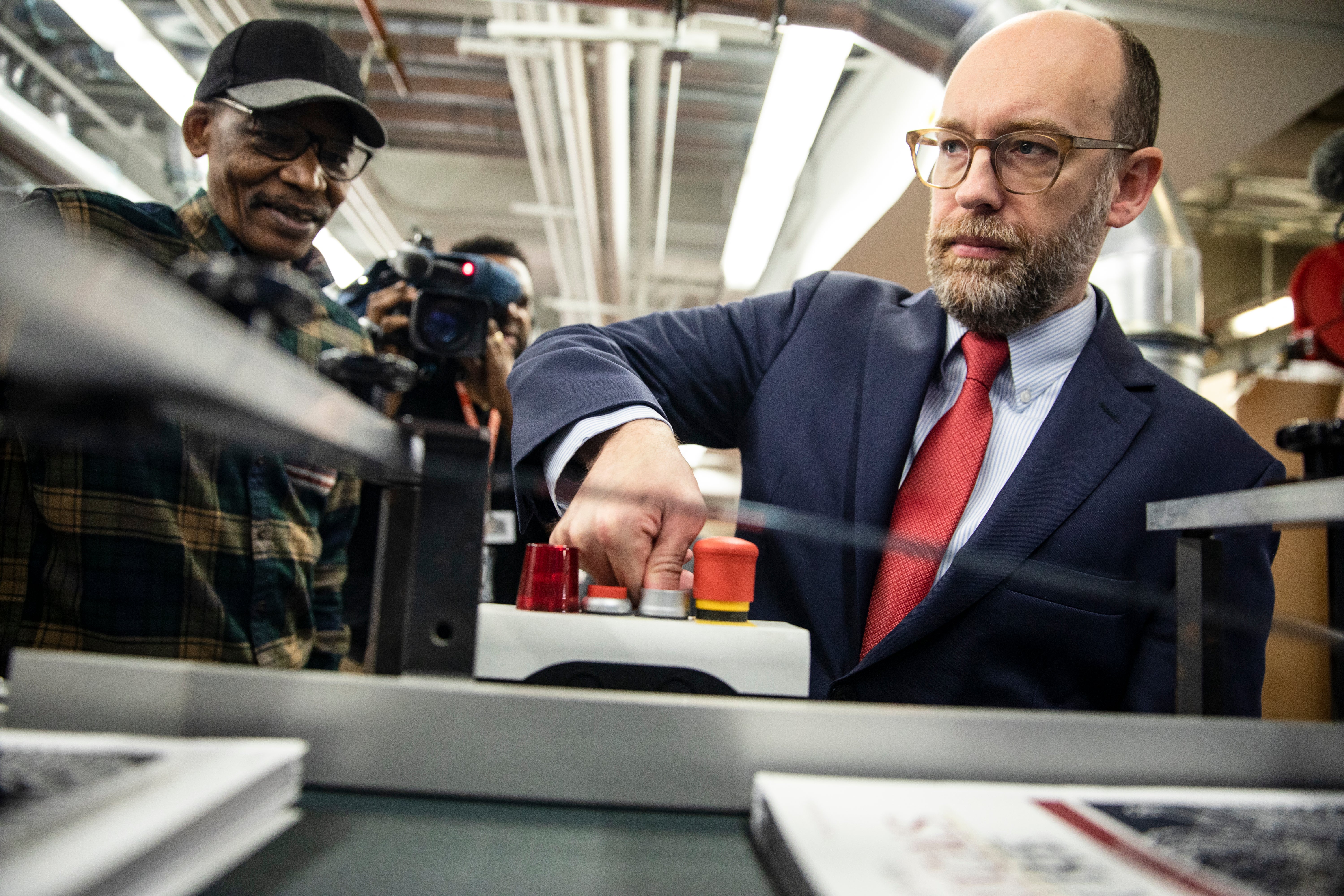 Russ Vought presses the button that starts the machine that will print copies of Donald Trump's proposed budget for the U.S. Government on February 6, 2020 in Washington, DC