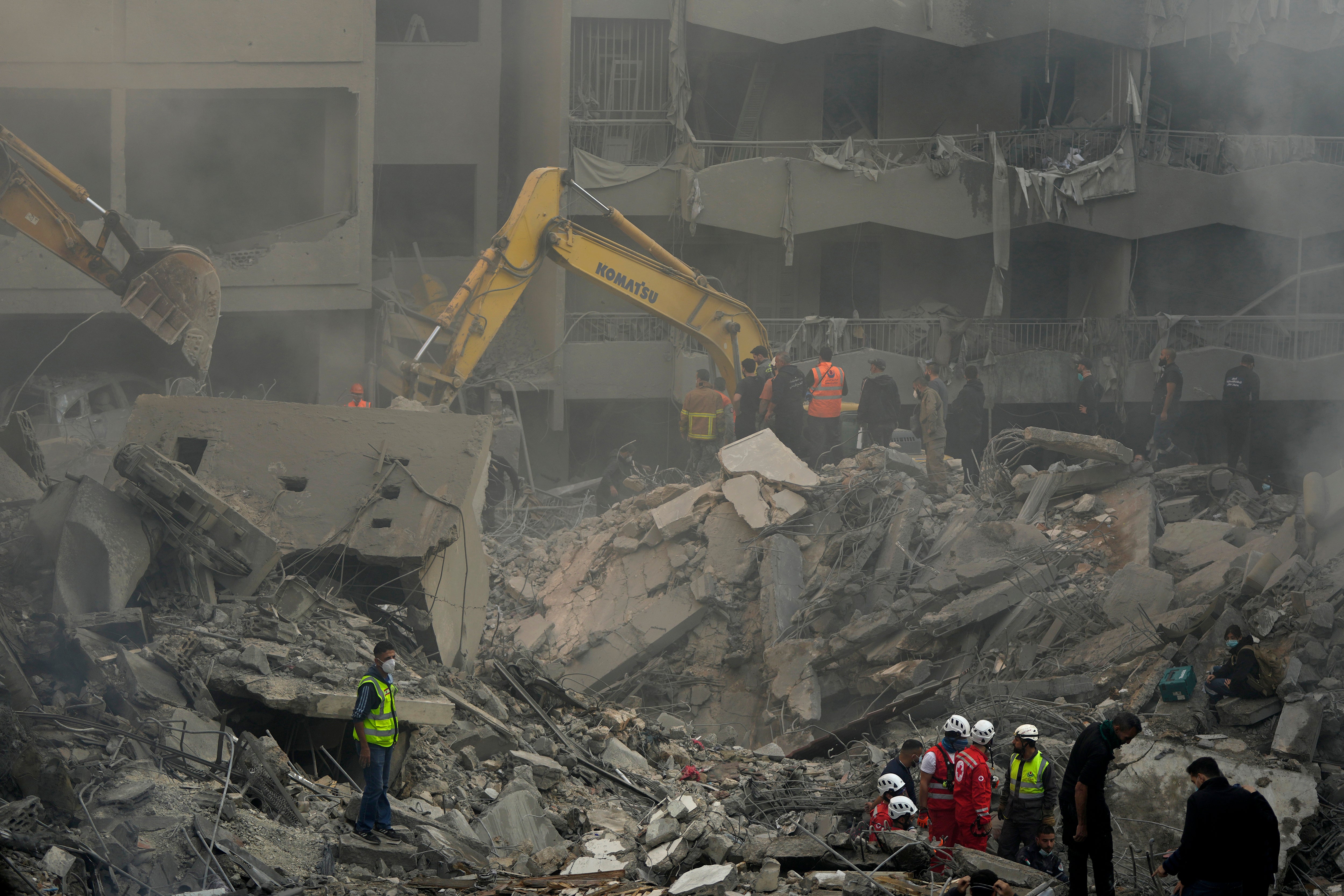 Rescue workers and volunteers search for victims at the site of an Israeli airstrike in central Beirut on 23 November 2024