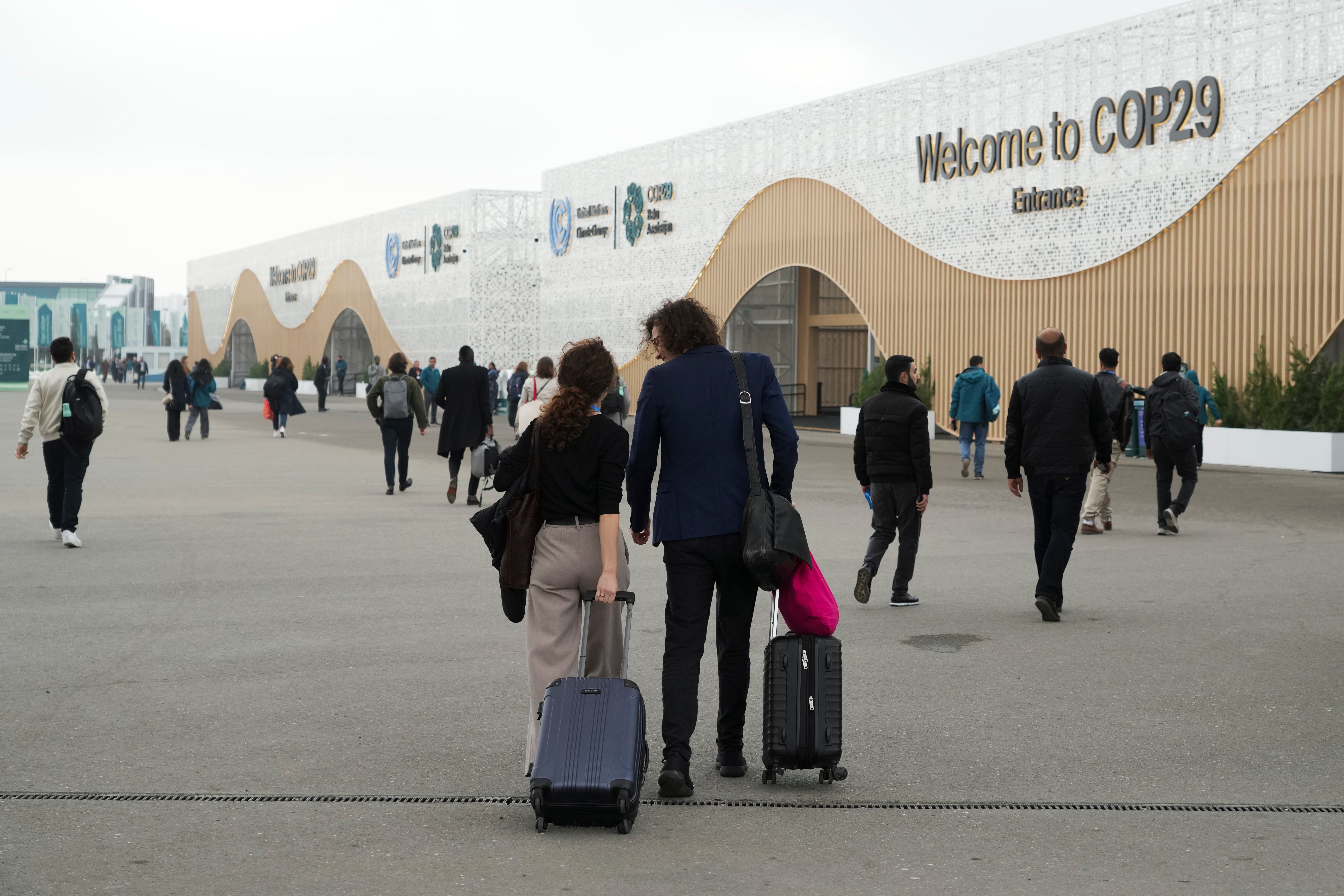 Attendees walk into the venue for the Cop29 UN Climate Summit on Saturday in Baku, Azerbaijan