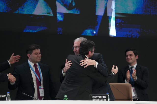 <p>Mukhtar Babayev, Cop29 President, and Yalchin Rafiyev, Azerbaijan's Cop29 lead negotiator, embrace after Babayev gavelled in a deal for money to curb climate change at the UN summit </p>