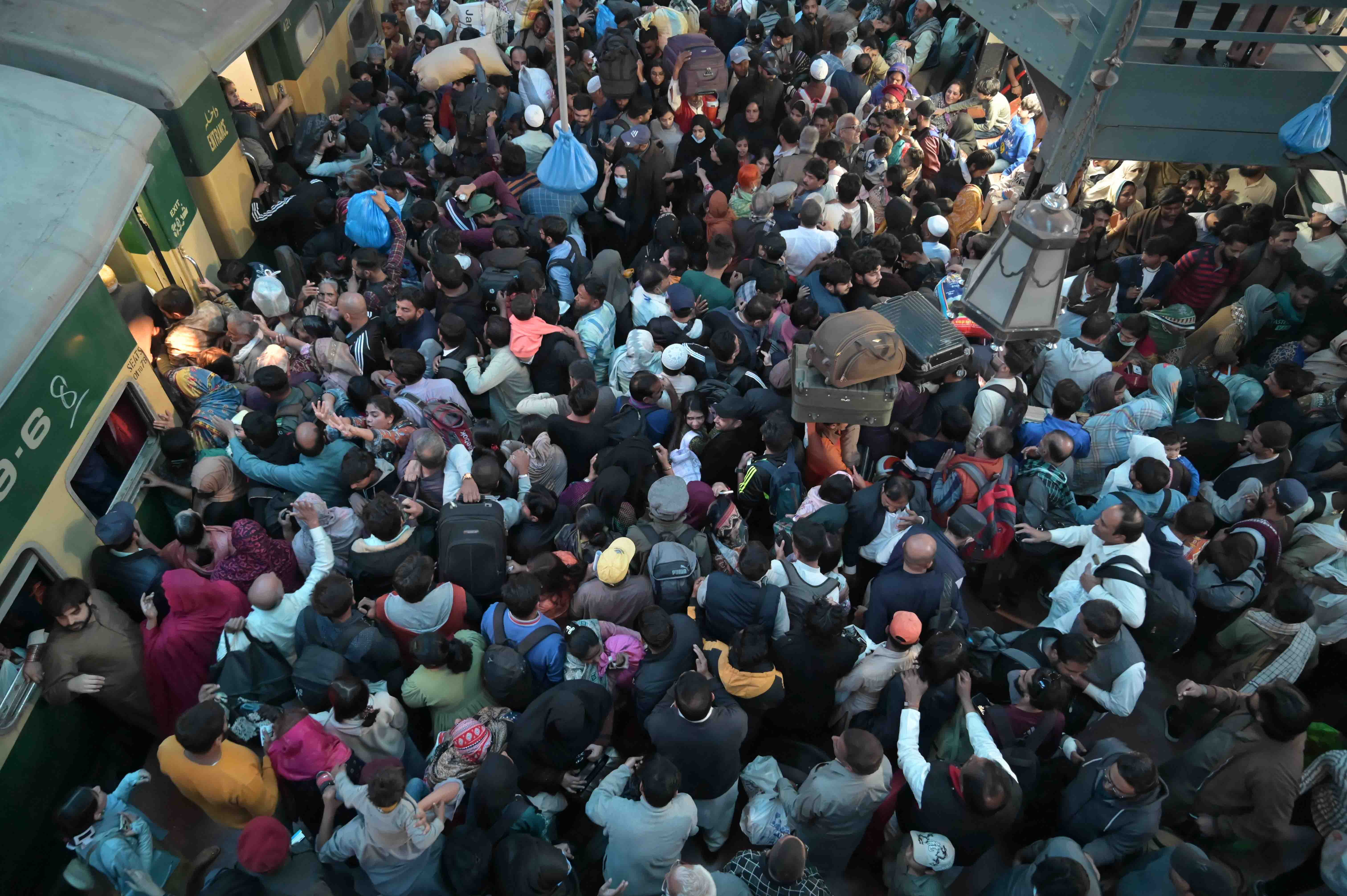 Passengers crowd a railway station after Pakistani authorities blocked motorways on the eve of a protest by opposition PTI party to demand the release of former prime minister Imran Khan