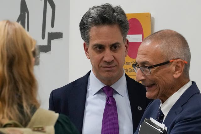 Ed Miliband (centre) speaks with US climate envoy John Podesta (right) at the Cop29 summit in Azerbaijan (Rafiq Maqbool/AP/PA)