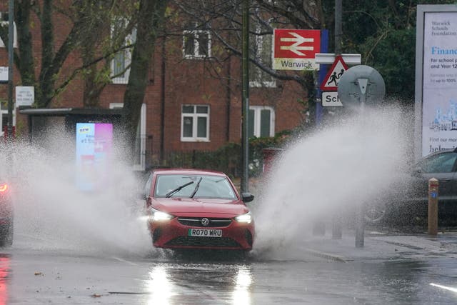 A vehicle is driven through floodwater after heavy rain in Warwick, with more than 200 flood alerts in place in the UK as Storm Bert continues to sweep across the country (Jacob King/PA)