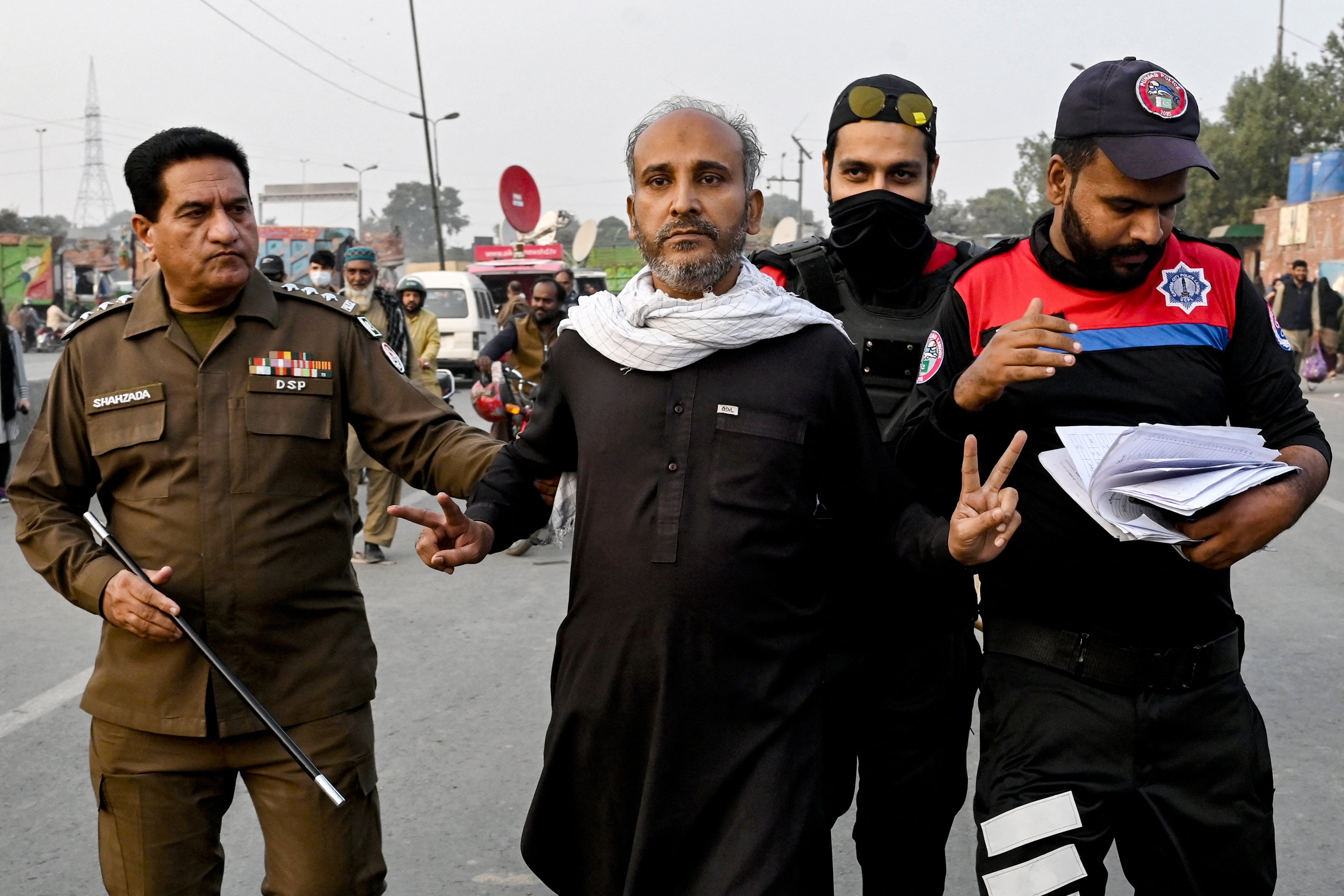<p>Security personnel detain a supporter of jailed former prime minister Imran Khan’s Pakistan Tehreek-e-Insaf (PTI) party during a protest demanding his release in Lahore</p>