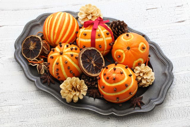 Cloves and oranges signify a Christmas scent (Alamy/PA)