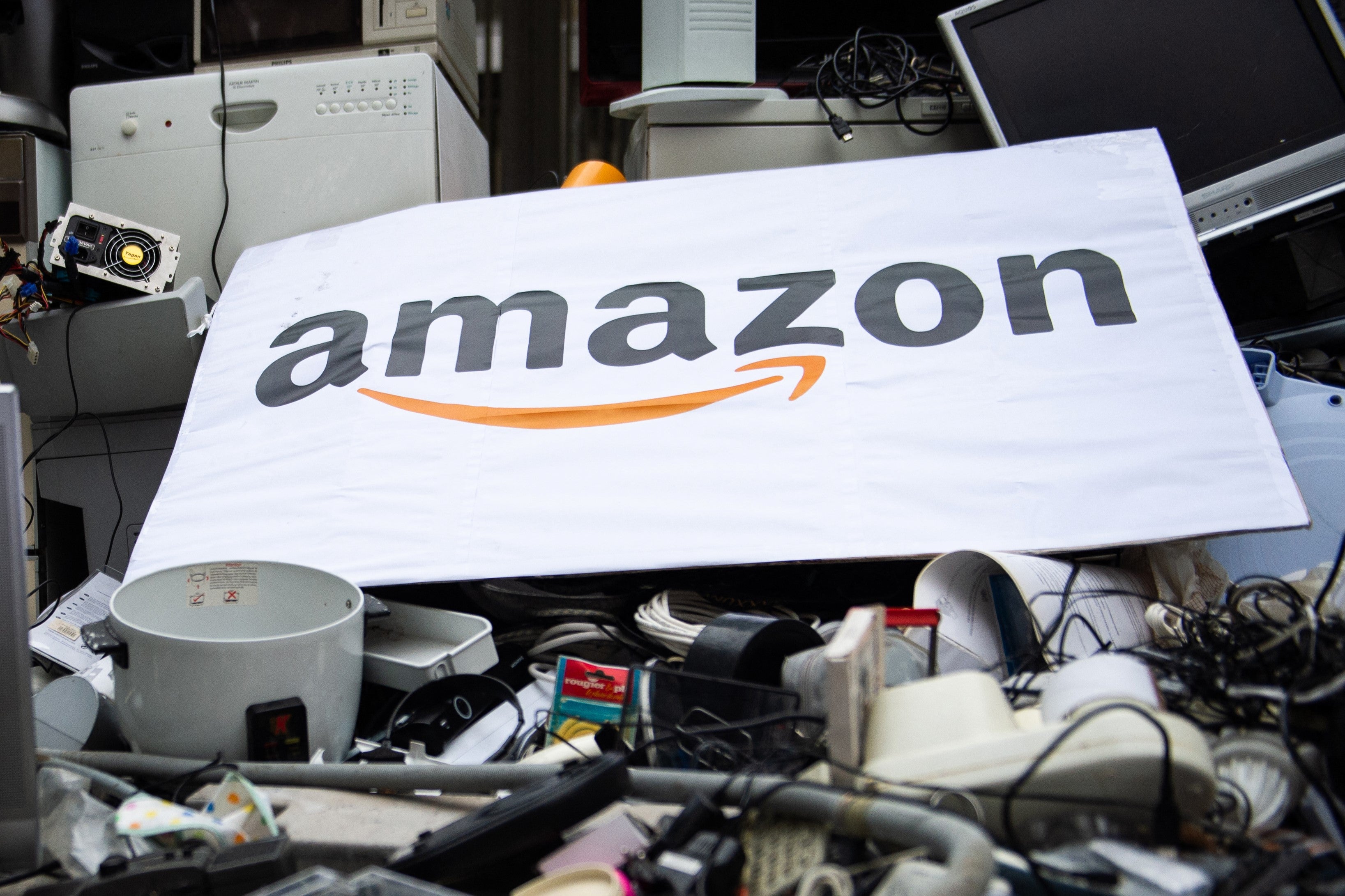 An Amazon placard on top of trashed appliances dumped by activists in front of the firm’s French headquarters ahead of Black Friday 2018