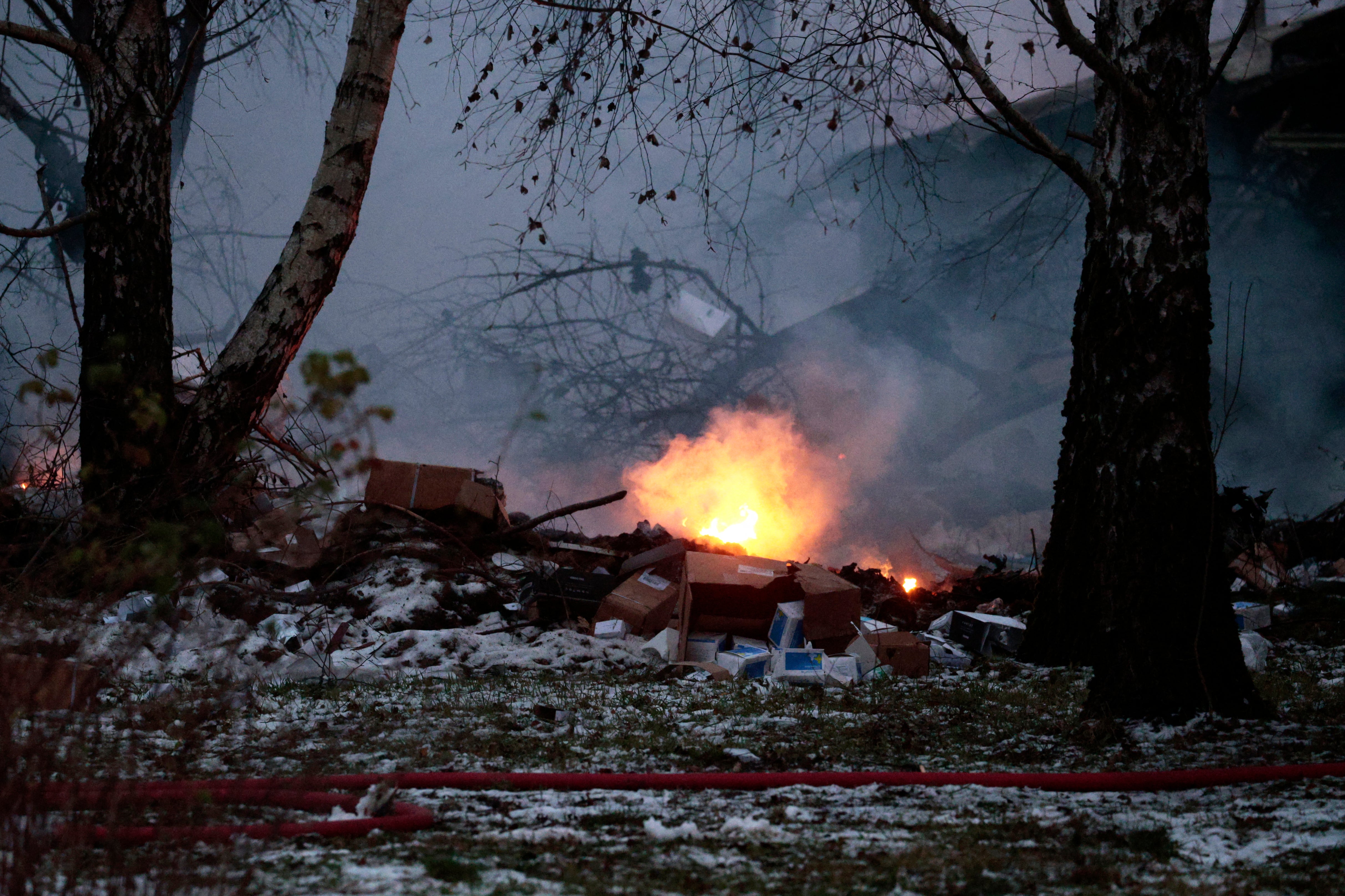 Burning goods are seen following the plane crash on Monday