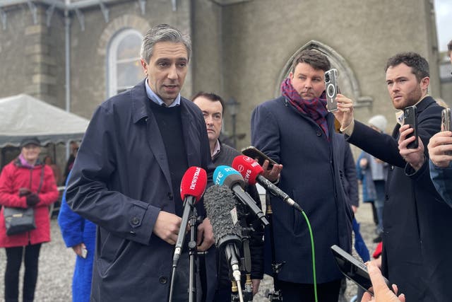 Taoiseach and Fine Gael leader Simon Harris canvasses at a Christmas market at Rathfarnham Parish Hall, Dublin (Grainne Ni Aodha/PA)