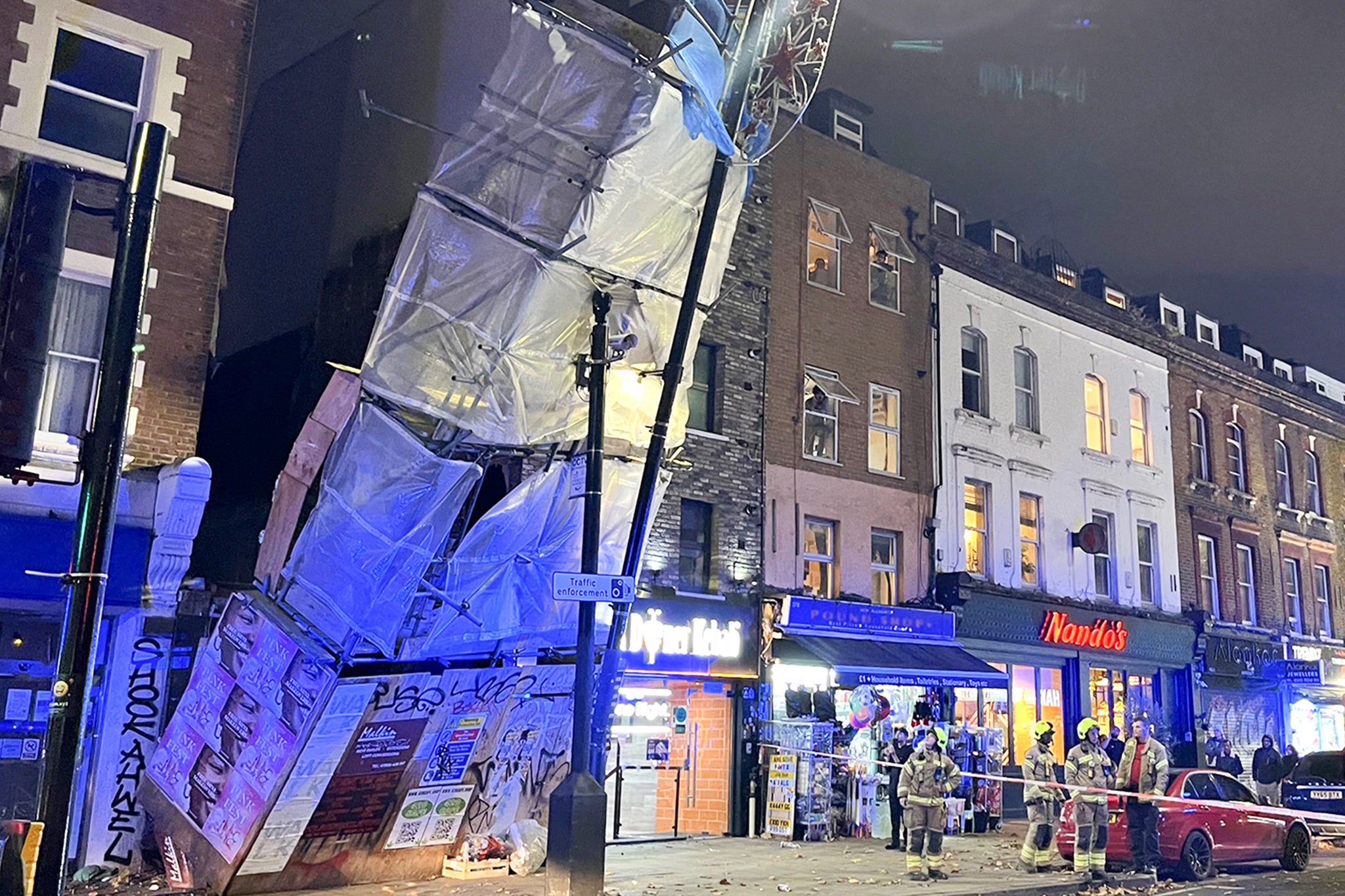 Emergency services at the scene of a scaffolding collapse in London during the storms