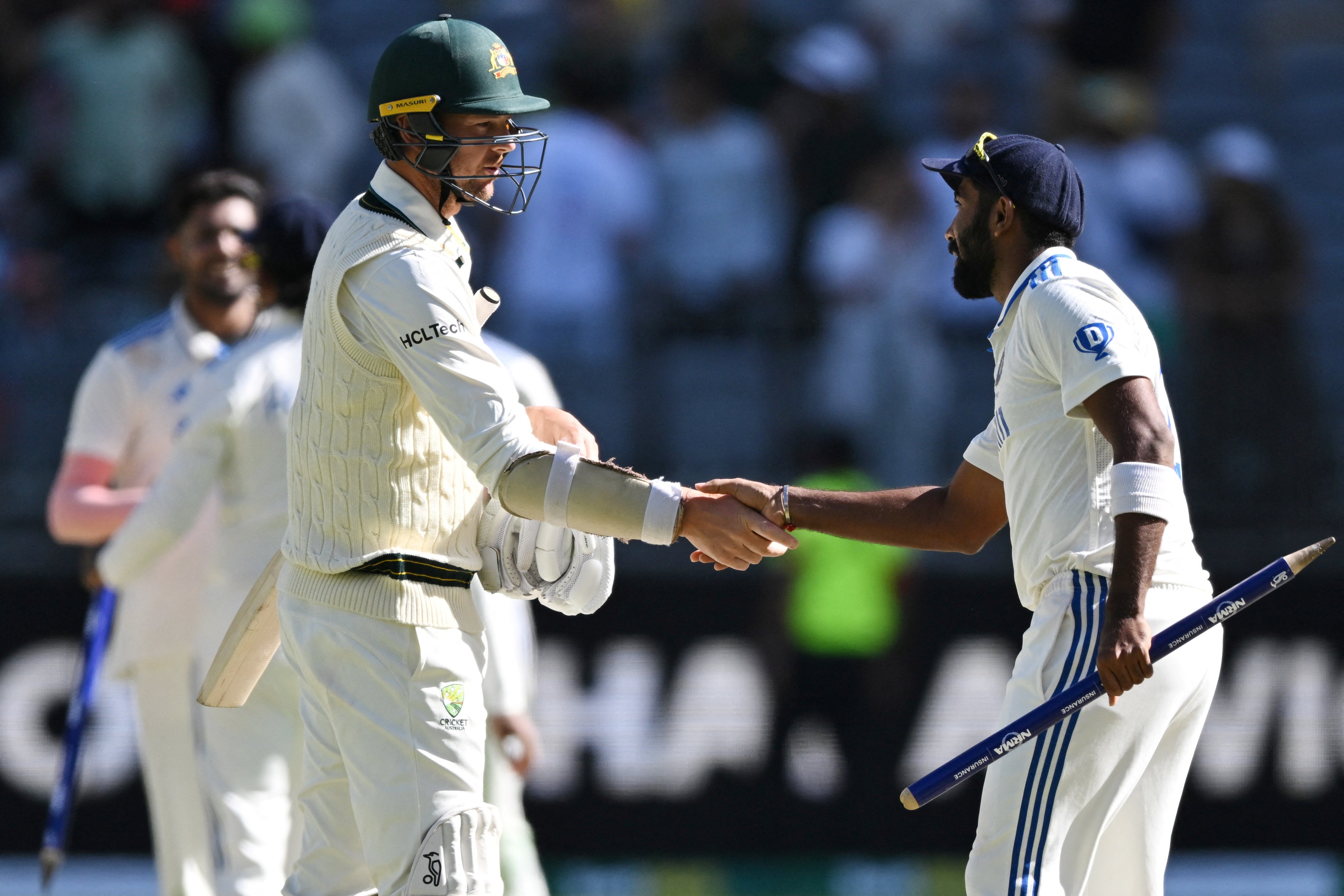 Australia's Josh Hazlewood shakes hands with India's Jasprit Bumrah