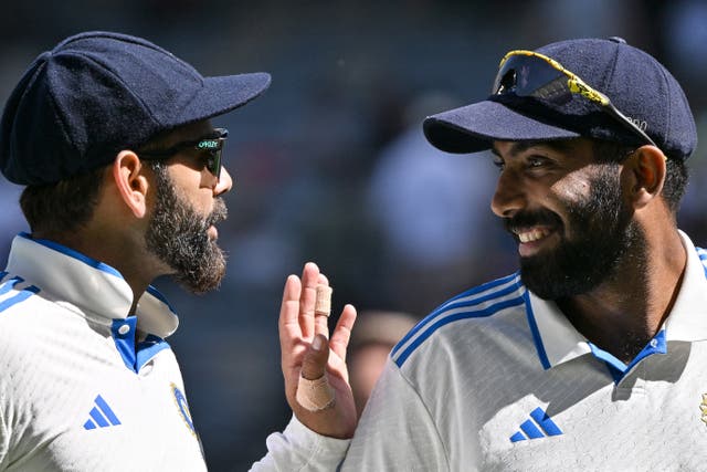 <p>India’s skipper Jasprit Bumrah and Virat Kohli chat at Optus Stadium in Perth</p>