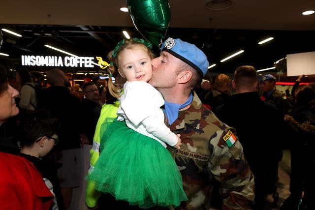 Corporal Paddy Brown with his daughter Molly after arriving home at Terminal 1 of Dublin Airport (Liam McBurney/PA)