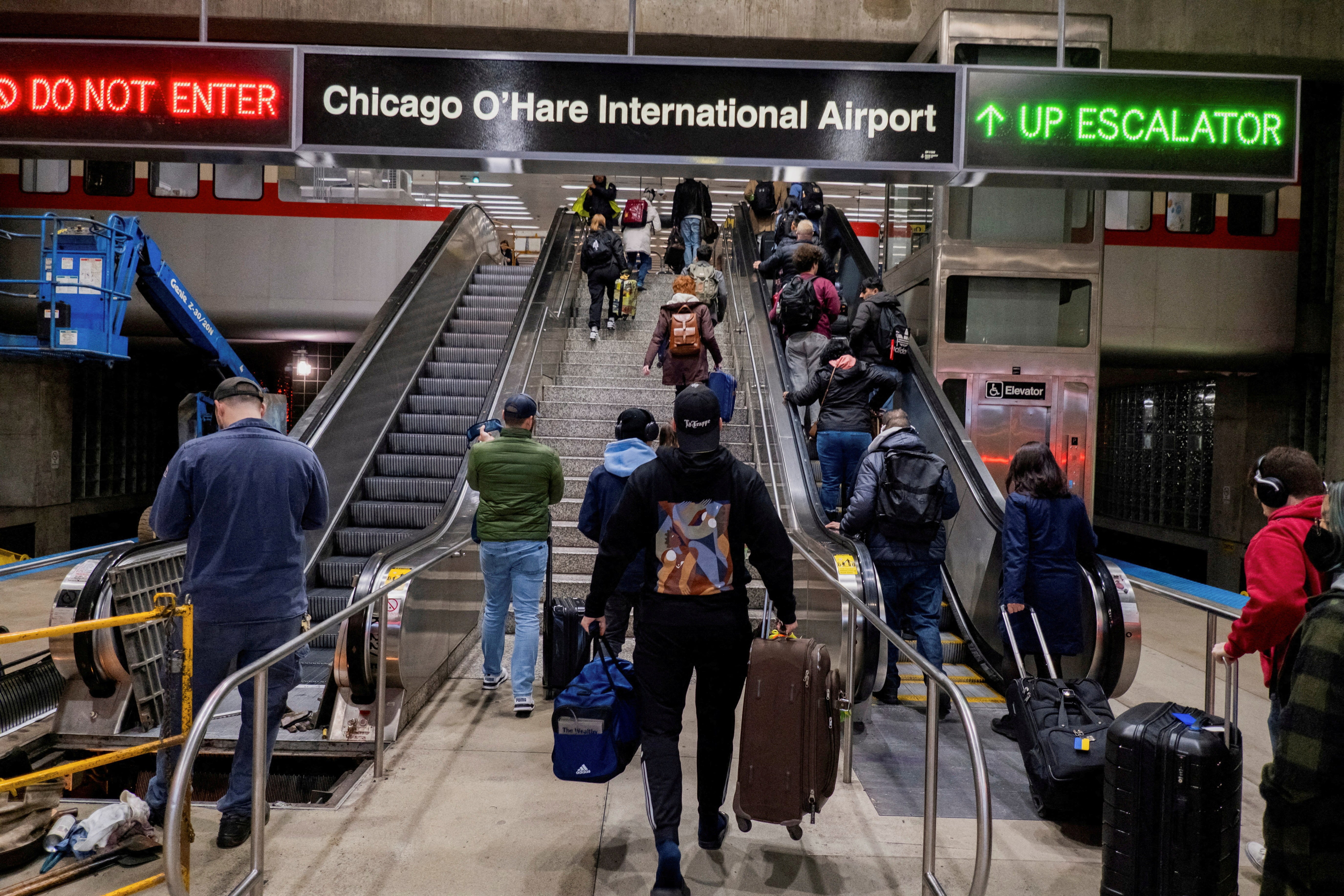 People walk through the O’Hare train station in Chicago. Parts of the Midwest will see several inches of snow on Monday