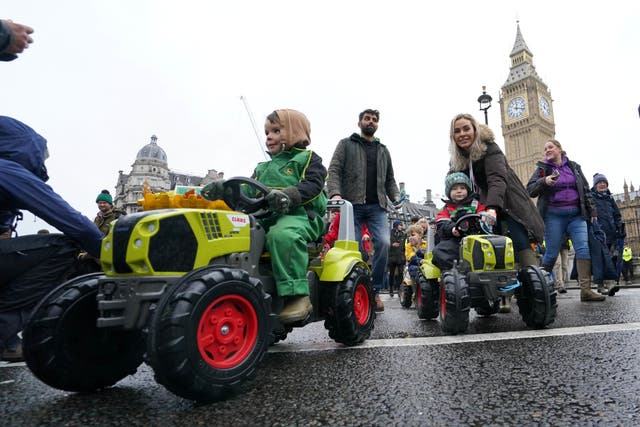 <p>Children on toy tractors during a farmers protest in central London over the changes to inheritance tax (Gareth Fuller/PA)</p>