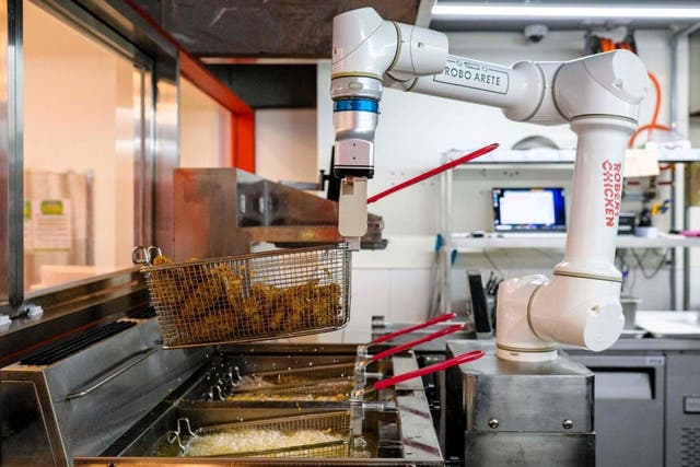 <p>A robot is used to fry chicken at a Robert Chicken restaurant in Seoul, South Korea, on 13 June, 2023</p>