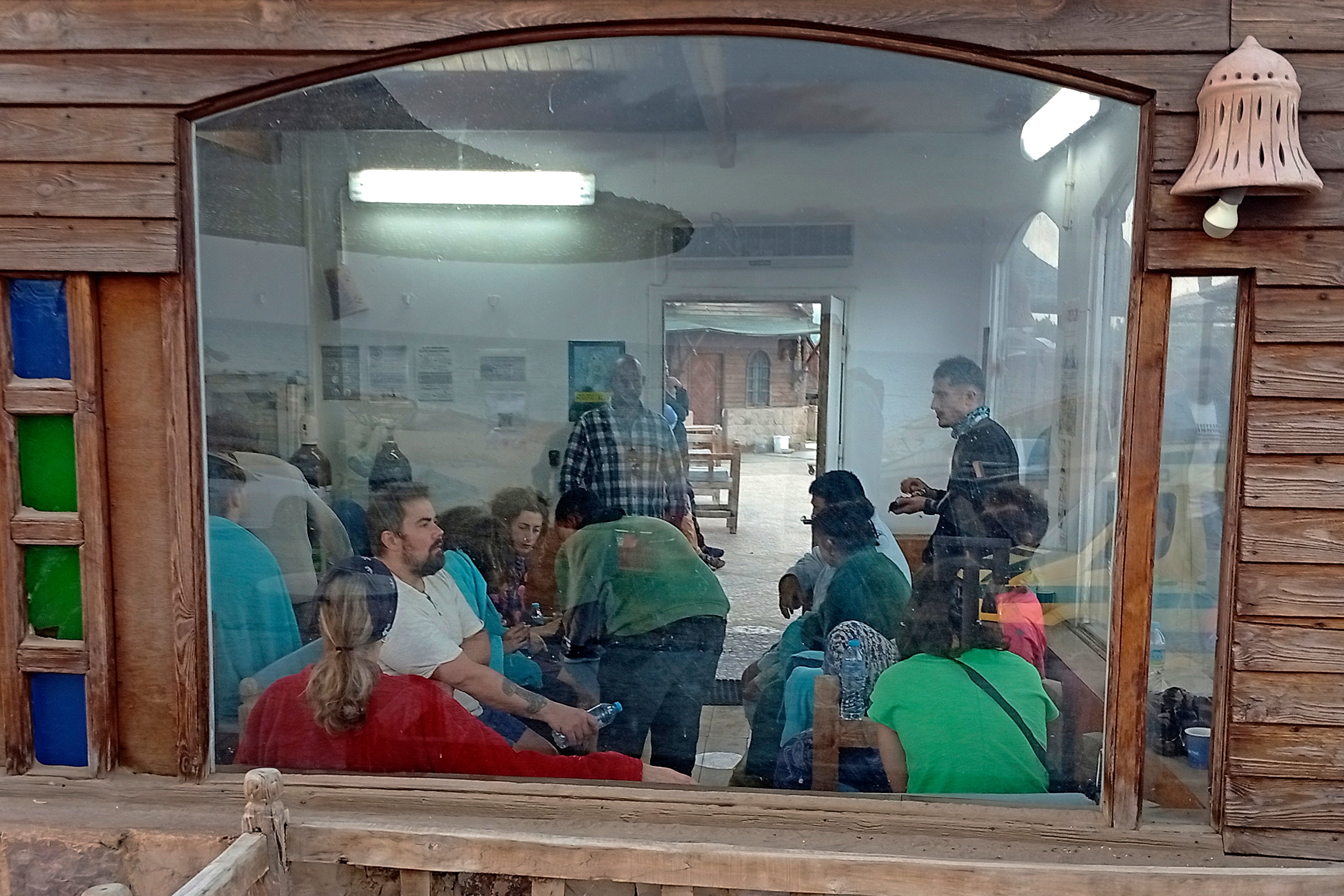 Survivors rest at a coffee shop in Marsa Alam after being rescued from the sunken vessel