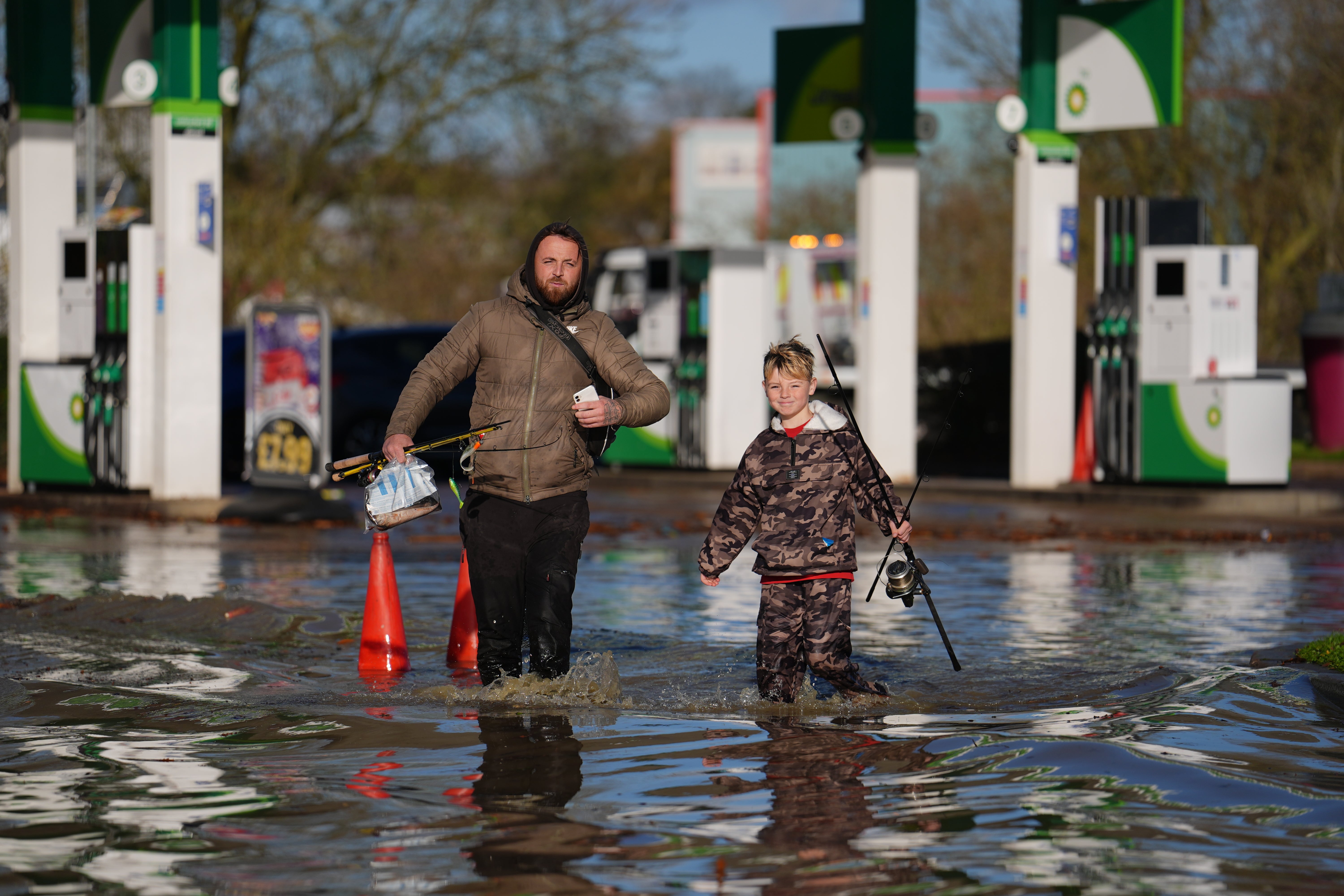 People wading through water near the Billing Aquadrome in Northamptonshire where around 1,000 people were evacuated from their homes