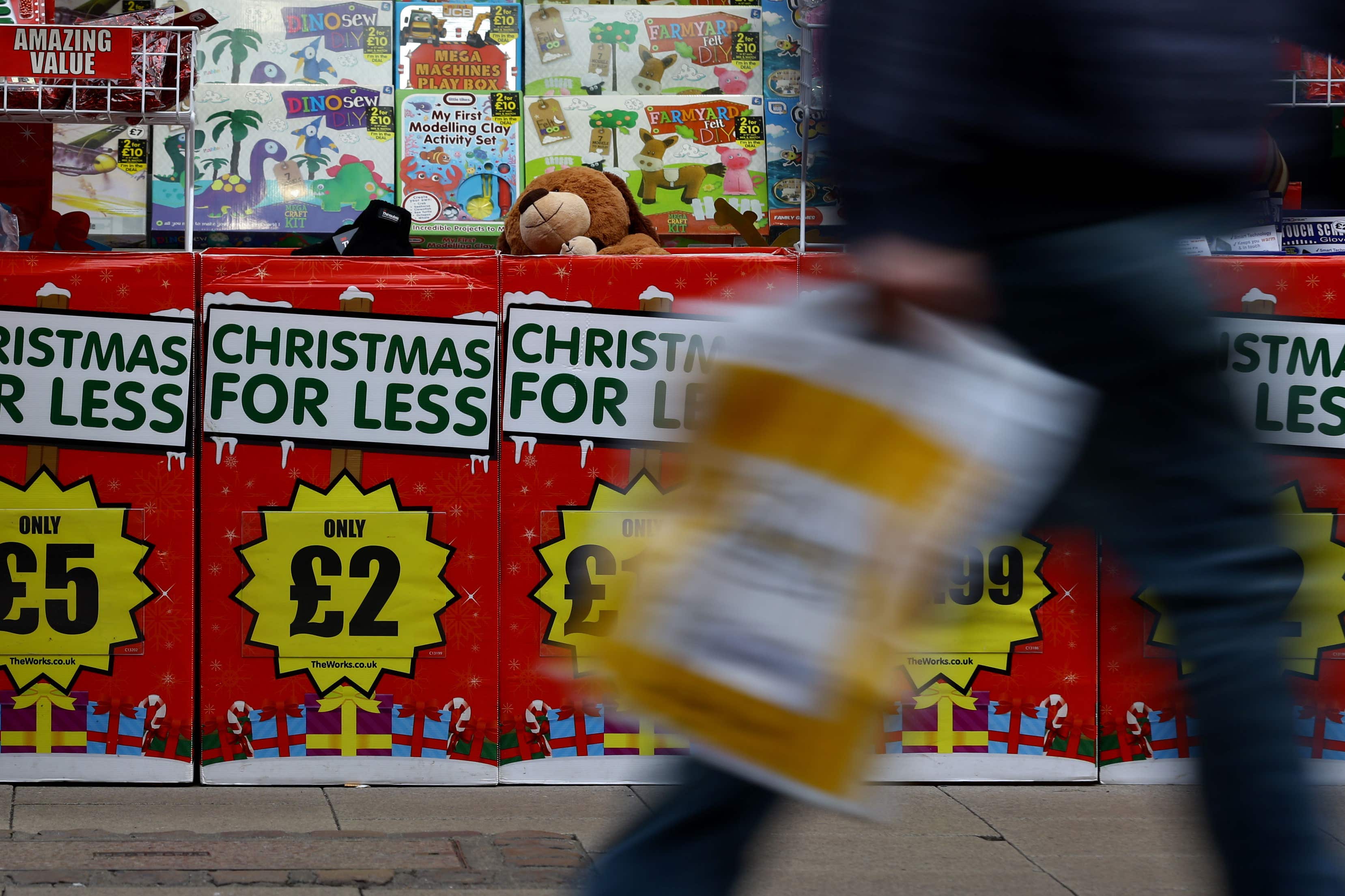 Adverts for Christmas goods in a shop window (Gareth Fuller/PA)