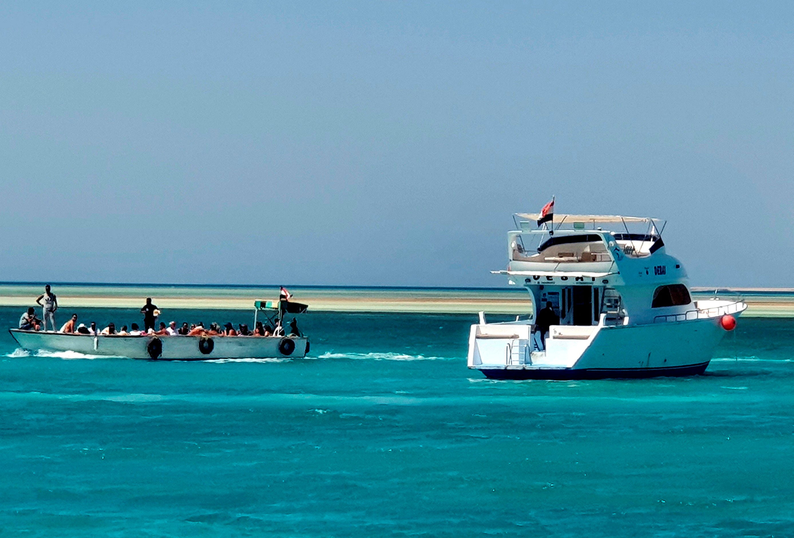 Tourists take a tour next to a docked yacht in the marina at the Egyptian Red Sea resort of Hurghada after a tourist boat sinks off Red Sea coast, Egypt 25 November 2024