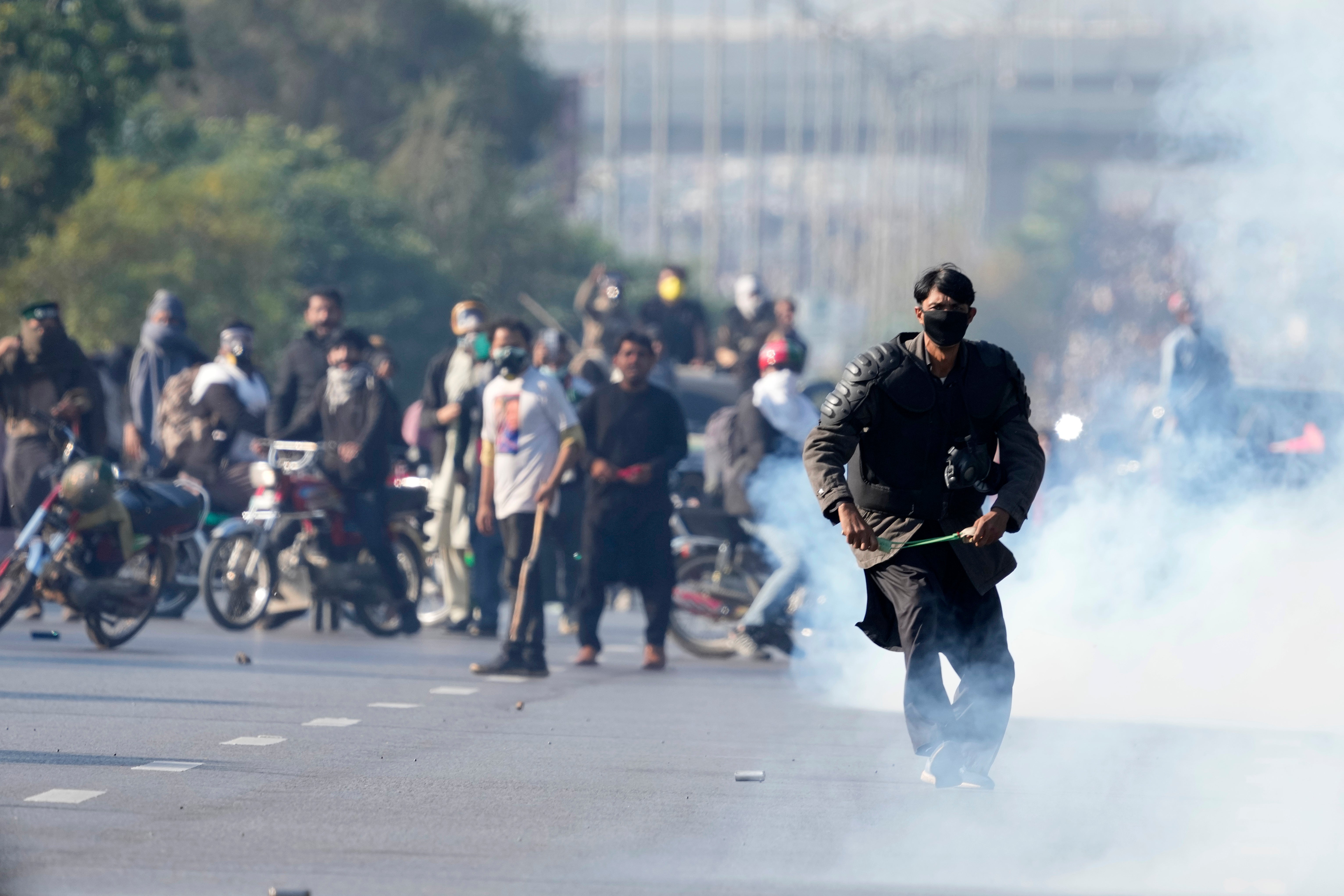 A supporter of imprisoned former premier Imran Khan's Pakistan Tehreek-e-Insaf party, prepares to throw stones