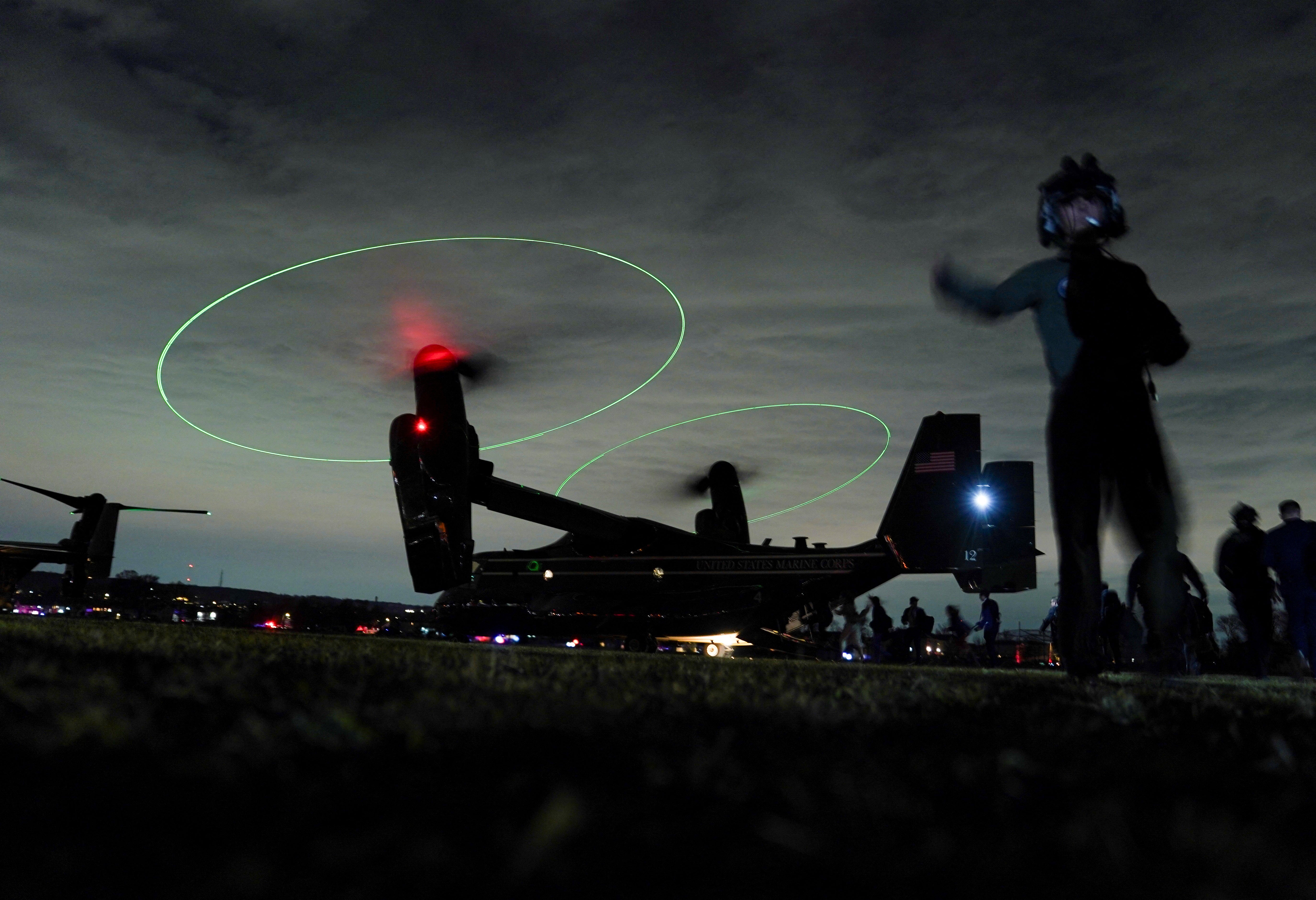 People in U.S. President Joe Biden's entourage board an Osprey aircraft at Staten Island, New York