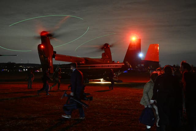 <p>Members of the White House Press pool (R) stand by an Osprey after US President Joe Biden and First Lady Jill Biden departed from Miller Field in Staten Island</p>