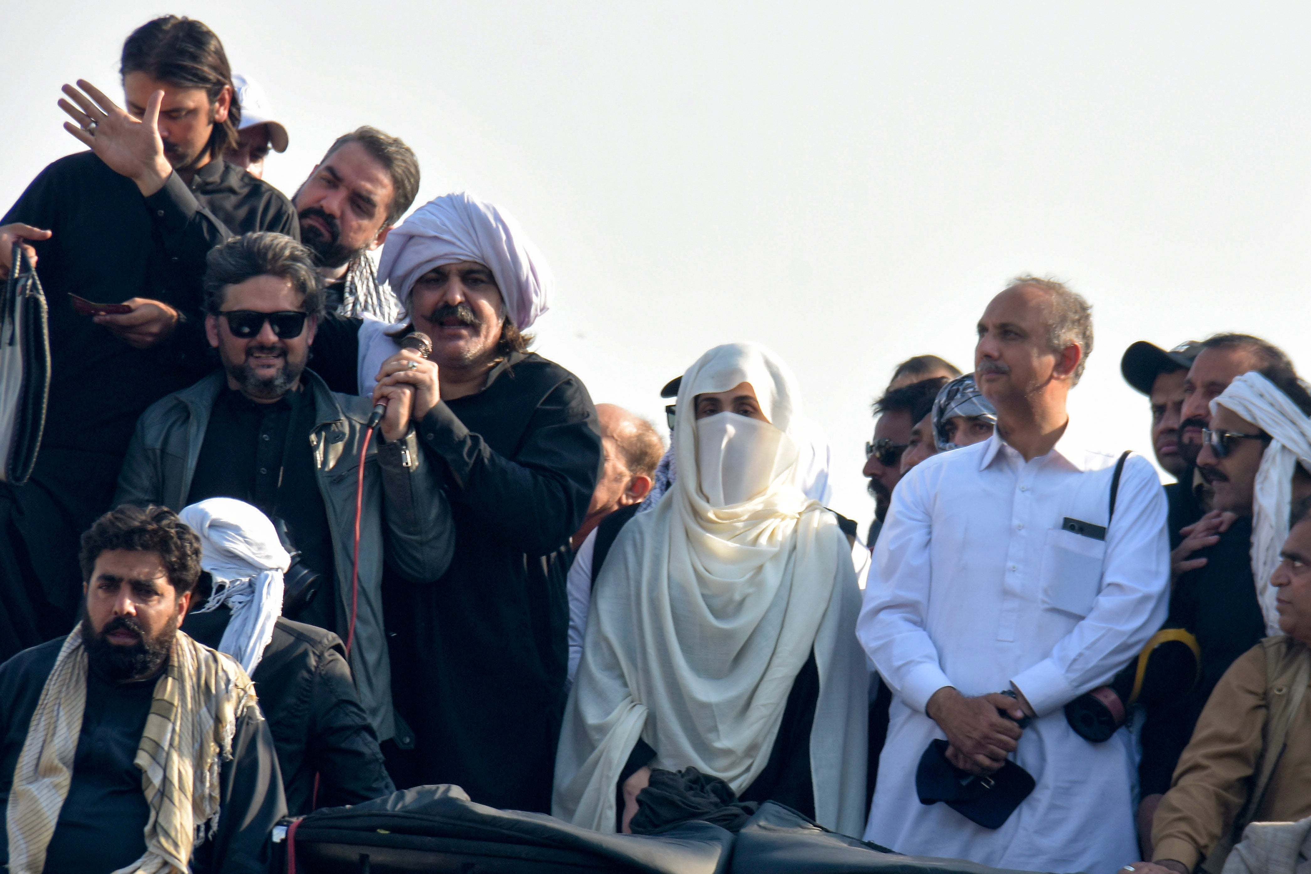 Bushra Bibi, center, woman  of imprisoned erstwhile  premier Imran Khan and leaders of Khan's enactment      pb  their supporters during a rally demanding Khan's release