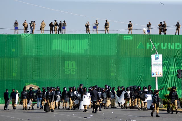 <p>Pakistan's army troops and police officers take positions at D-Chowk square close to Red Zone, which is an area that houses key government buildings</p>