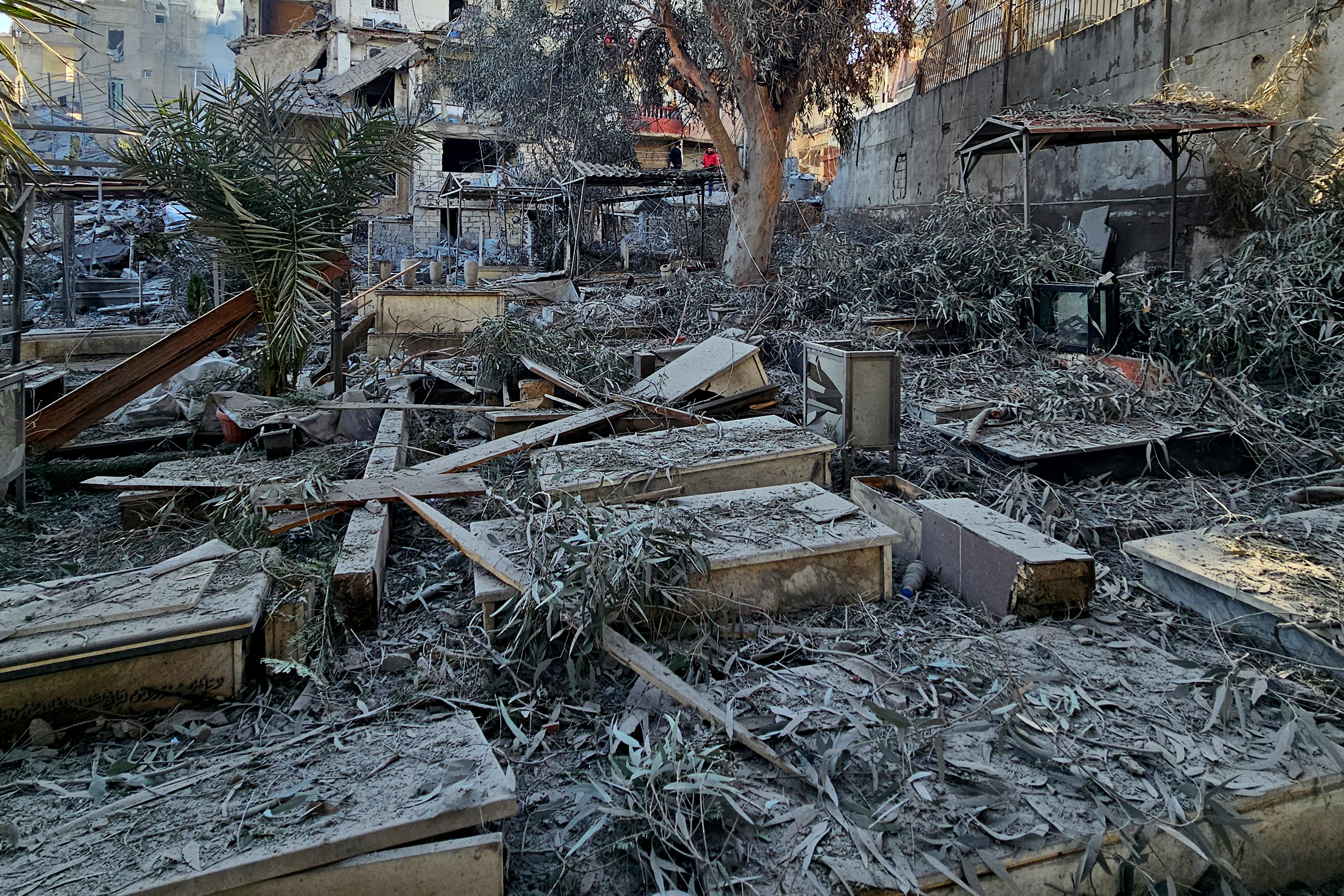 This image shows a damaged cemetery at the site of an Israeli airstrike that targeted a building in the Beirut