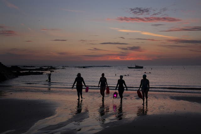 Pre-dawn swimmers at Cullercoats, Tynemouth (Owen Humphreys/PA)