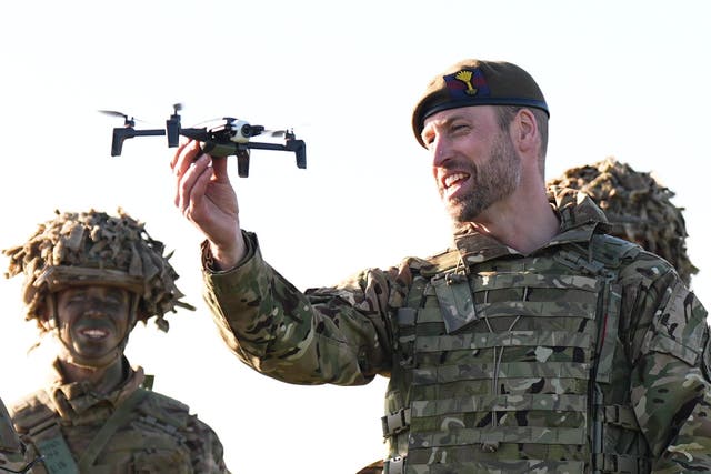 The Prince of Wales holding a drone (Aaron Chown/PA)