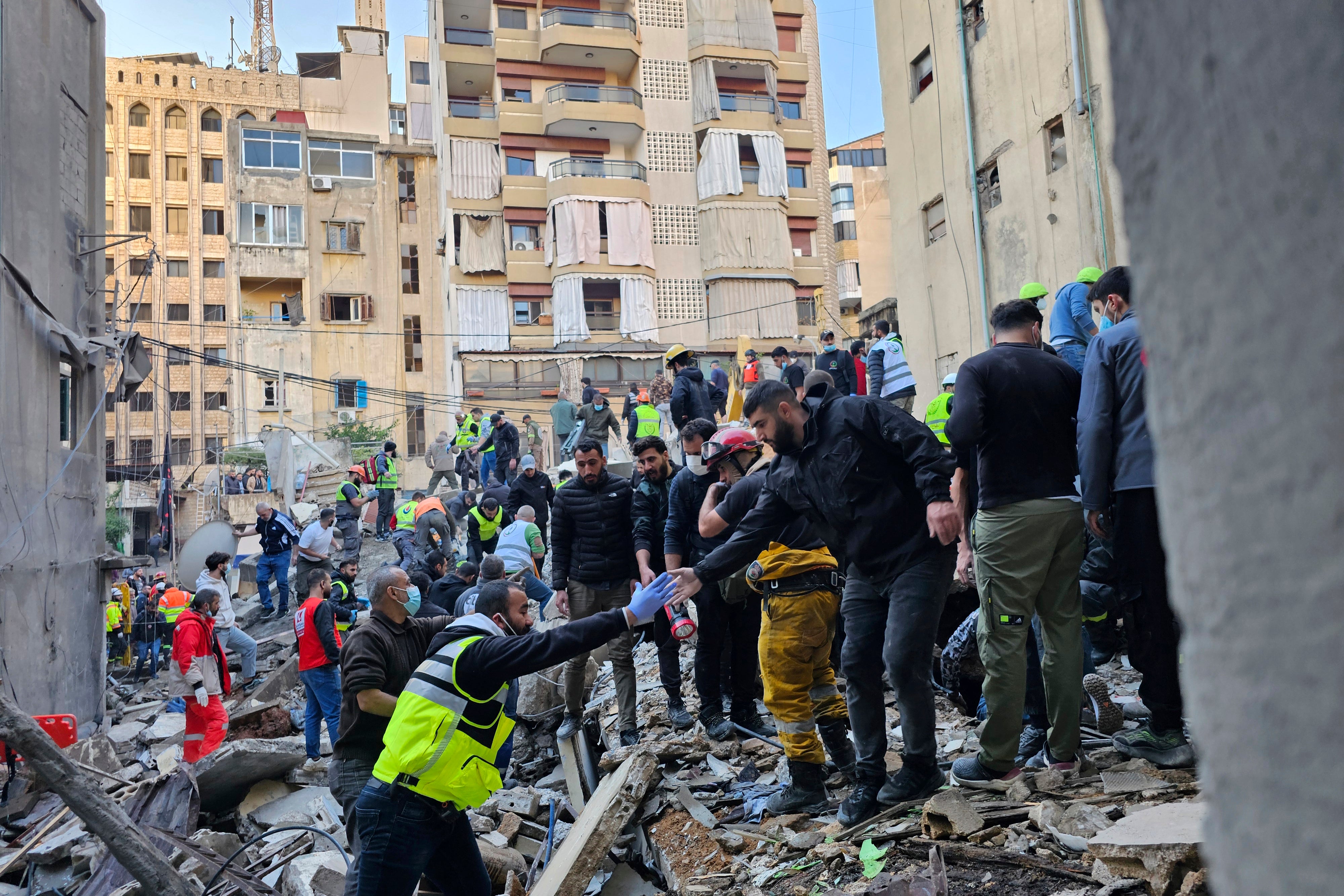 Rescuers search for victims at the site of an Israeli airstrike that targeted a building in Beirut, Lebanon on Tuesday