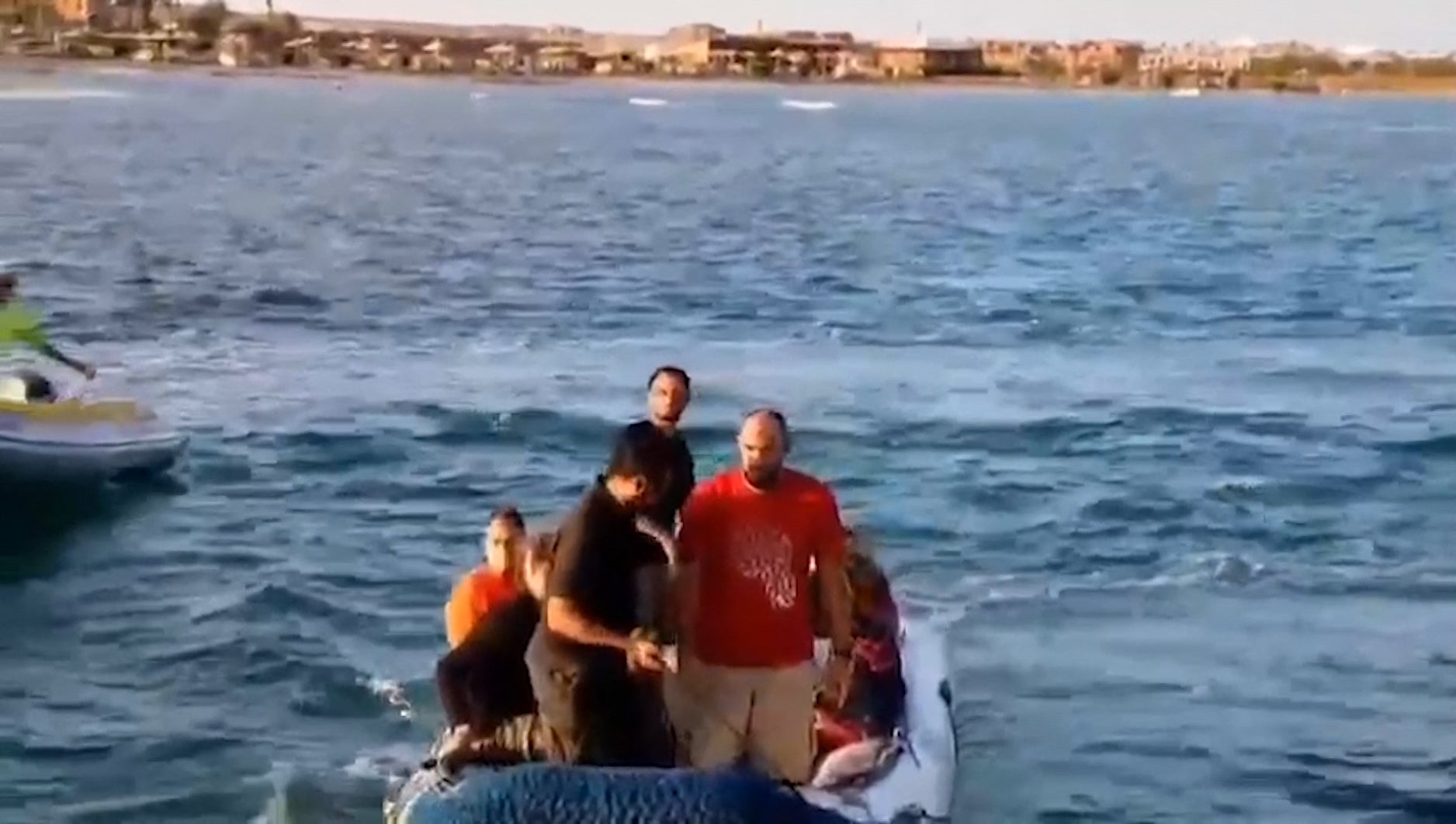 Rescue workers bring boat survivors to safety