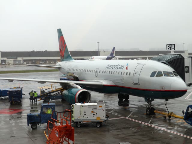 <p>An American Airlines plane sits at the gate at Boston Logan International Airport</p>