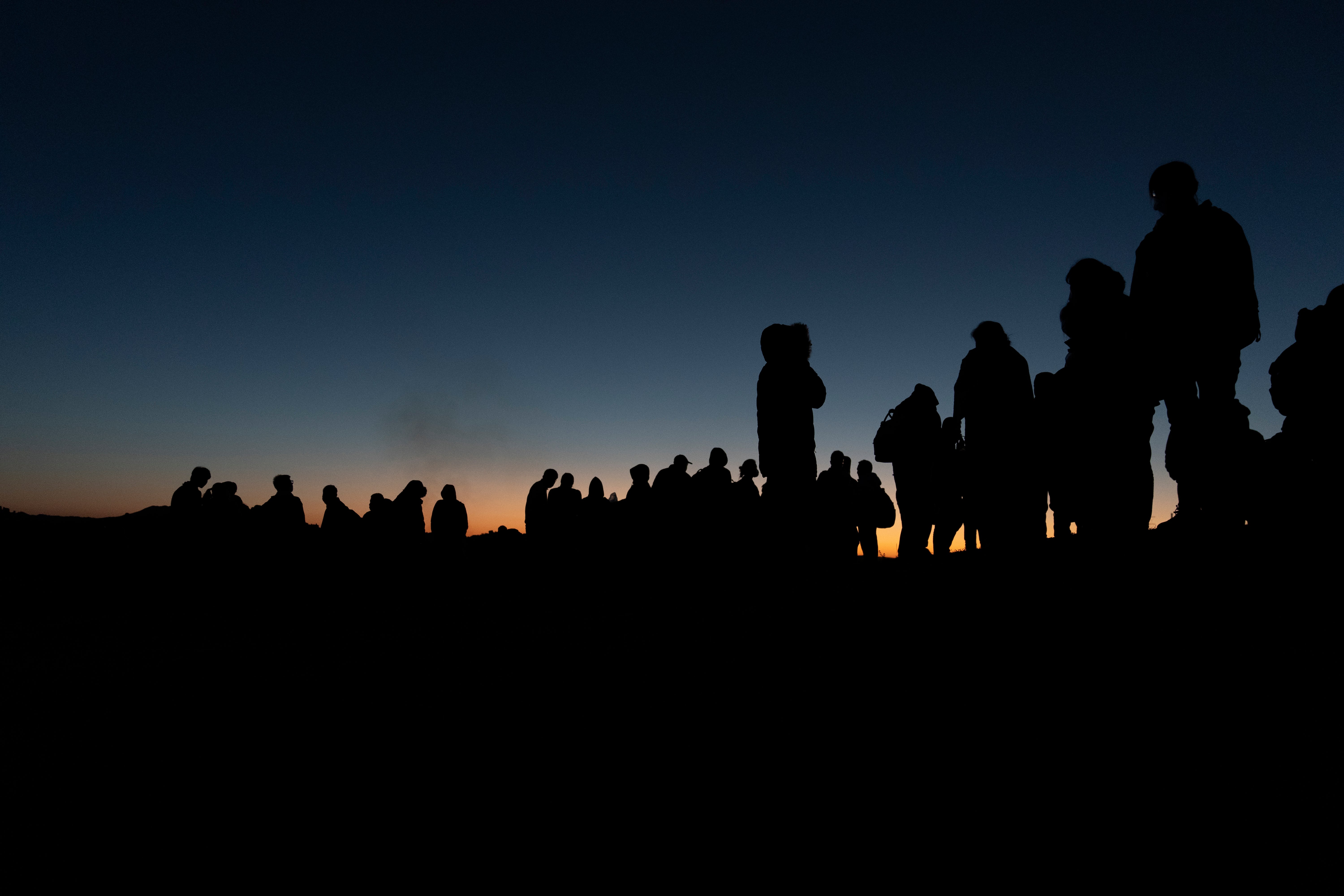 Chinese migrants wait to be processed after crossing the border with Mexico in May 2024 near Jacumba Hot Springs, California