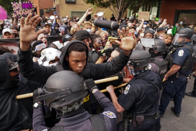 <p>Police and protesters converge during a demonstration over the death of Breonna Taylor in September 2020 </p>