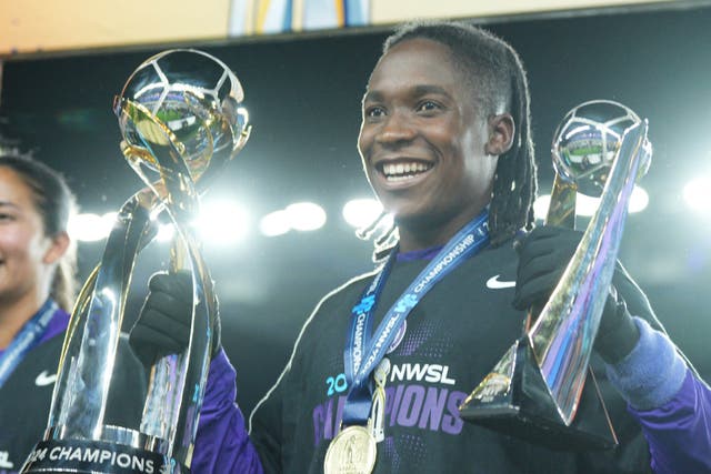 <p>Barbra Banda celebrates with the NWSL championship and MVP trophies</p>