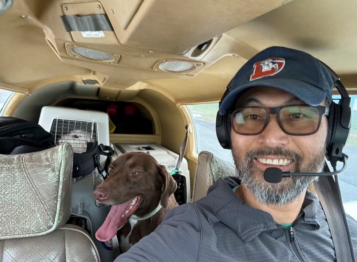 This photo released by The Animal Shelter of Schoharie Valley shows Seuk Kim during a flight to deliver dogs rescued from a euthanasia list to the Animal Shelter of Schoharie County on Nov. 11, 2024. (Animal Shelter of Schoharie Valley via AP)