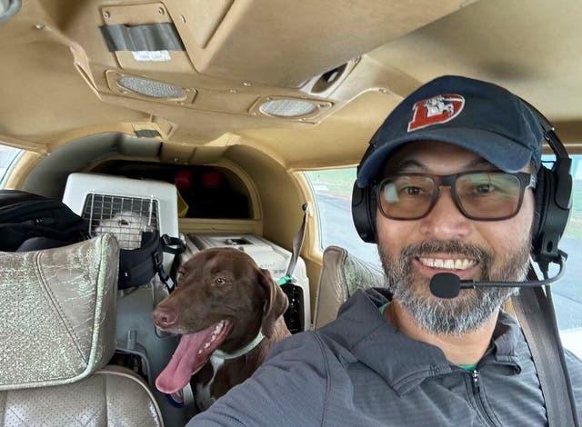 <p>This photo released by The Animal Shelter of Schoharie Valley shows Seuk Kim during a flight to deliver dogs rescued from a euthanasia list to the Animal Shelter of Schoharie County on Nov. 11, 2024. (Animal Shelter of Schoharie Valley via AP)</p>